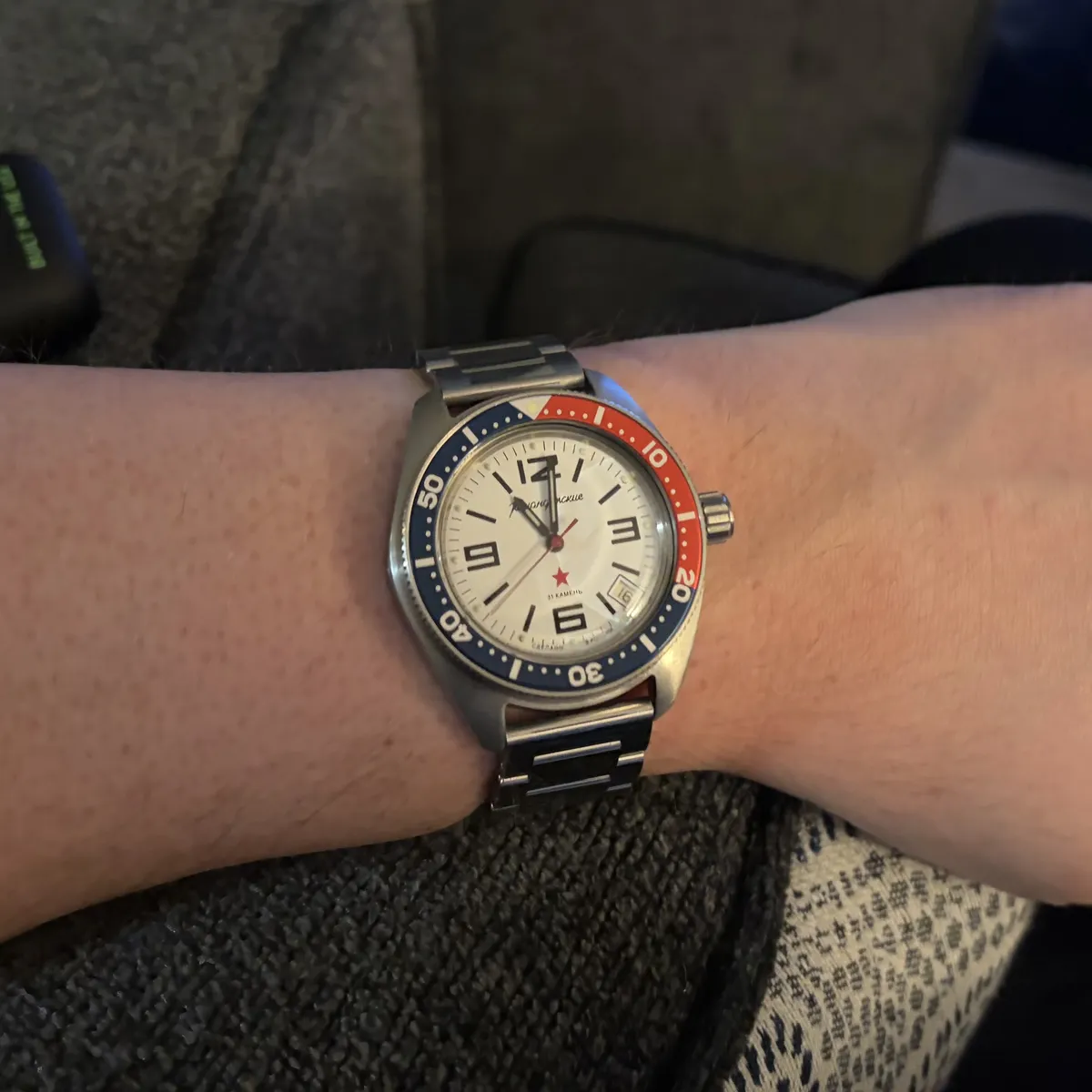 Stainless steel watch with a red and blue “Pepsi” bezel