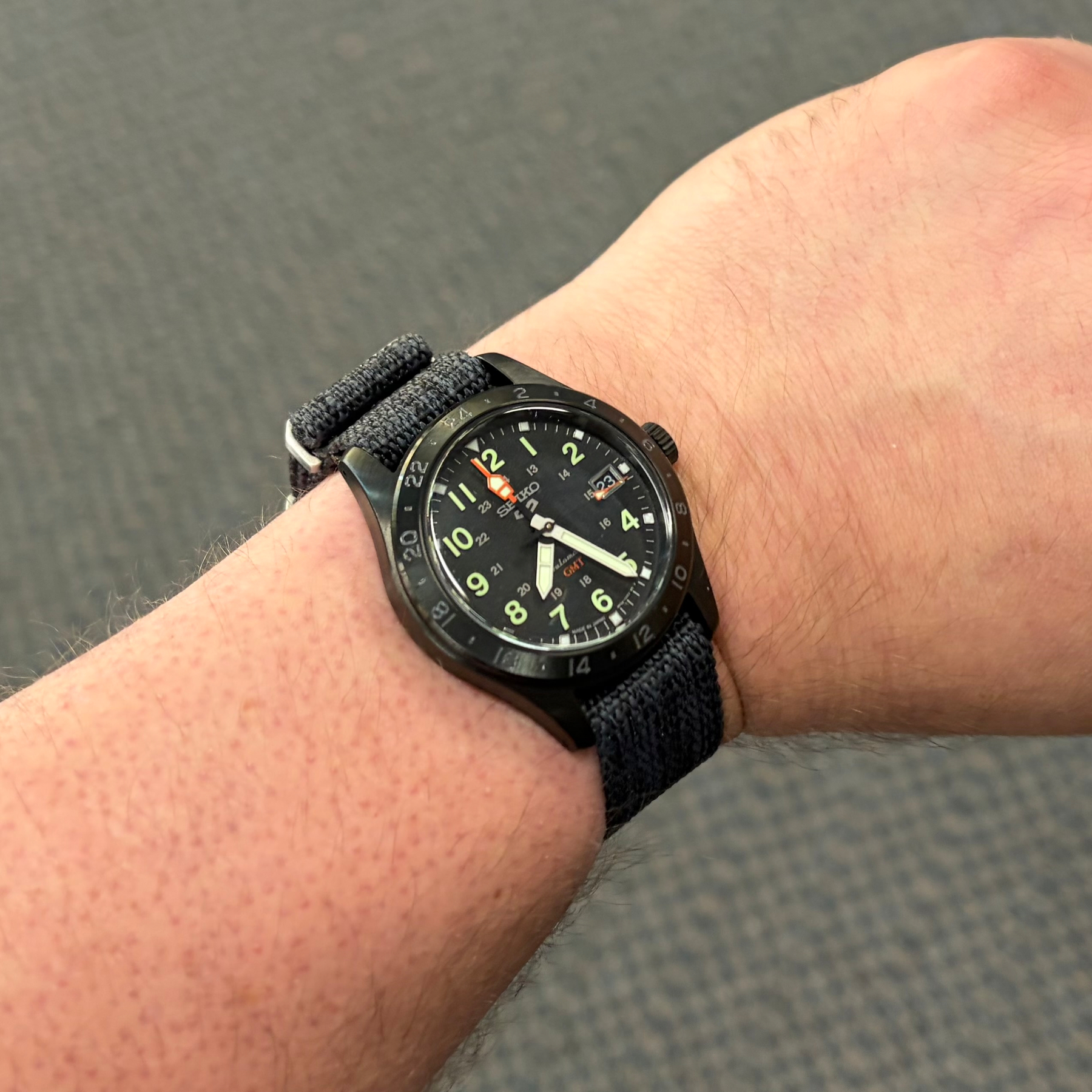 Black Seiko 5 GMT with a dark gray nato strap